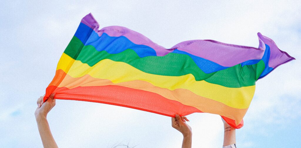 People holding the rainbow pride flag 
