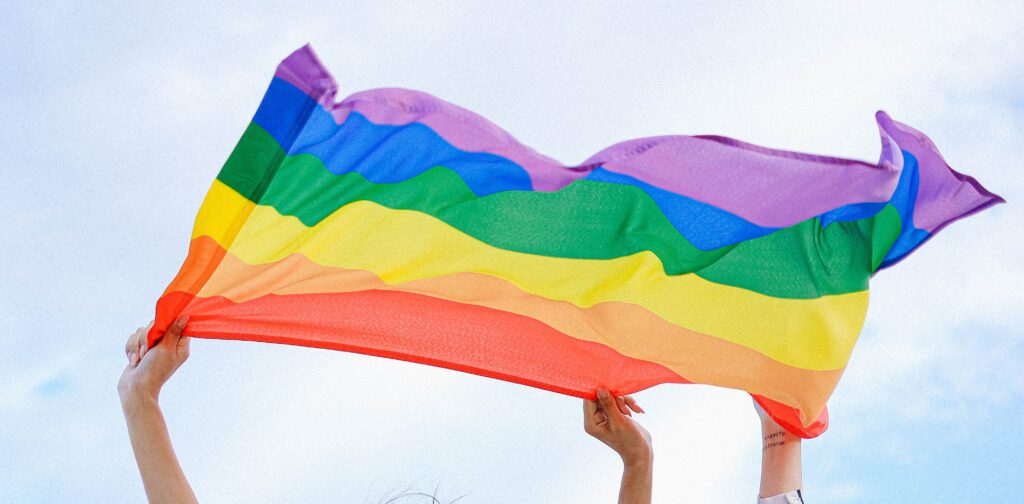 People holding the rainbow pride flag
